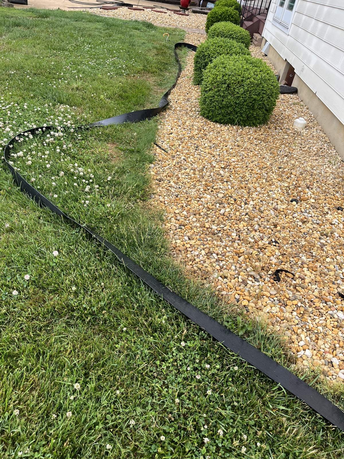 River Rock Bed & Edging — Top Notch Property Services